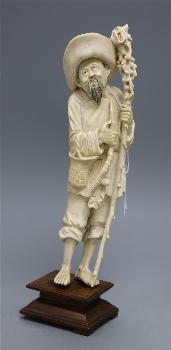 An early 20th century Chinese ivory figure of a farmer